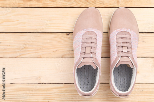 sneakers on wooden background with copy space. Top view. Vintage effect.