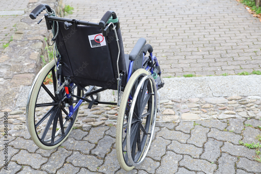 A Wheelchair in a street to illustrate the difficulties of people with disabilities