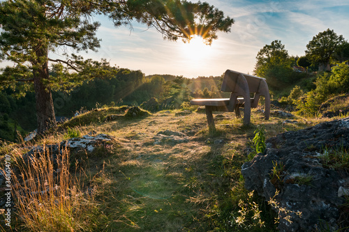 Bench on rock hillside of Franconian Switzerland, sunset on summer evening