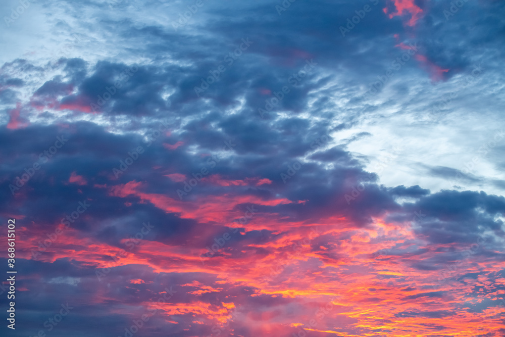 Fototapeta premium Dramatic clouds at sunset after a storm with orange and purple