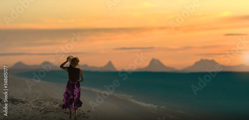 girl walking on a tropical beach in sunset.
