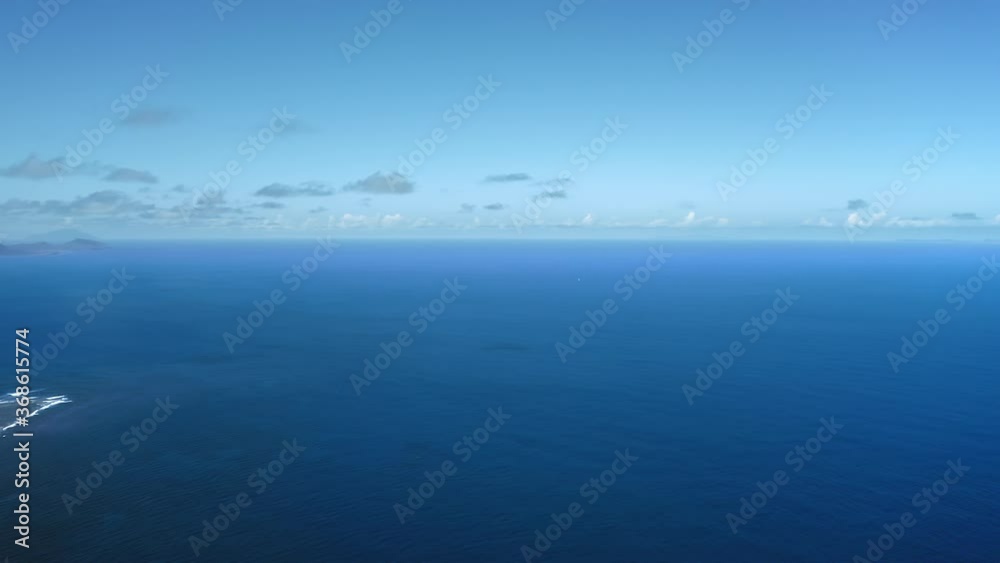 Aerial panorama of azure sea and shadow of the mountain in the distance in Saint Kitts and Nevis Aerial panorama of azure sea and shadow of the mountain in the distance in Saint Kitts and Nevis