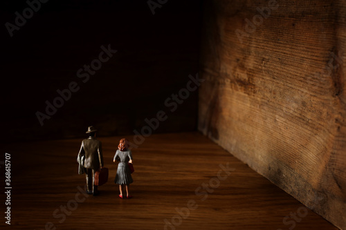 A concept image of a woman and man who facing a dead end and has a wall in front of them. An idea of overcoming fear and obstacle