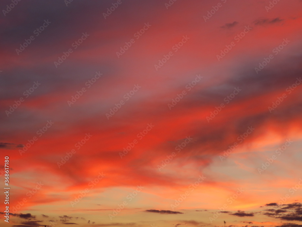 Beautiful sunset clouds fire red dawn reflection