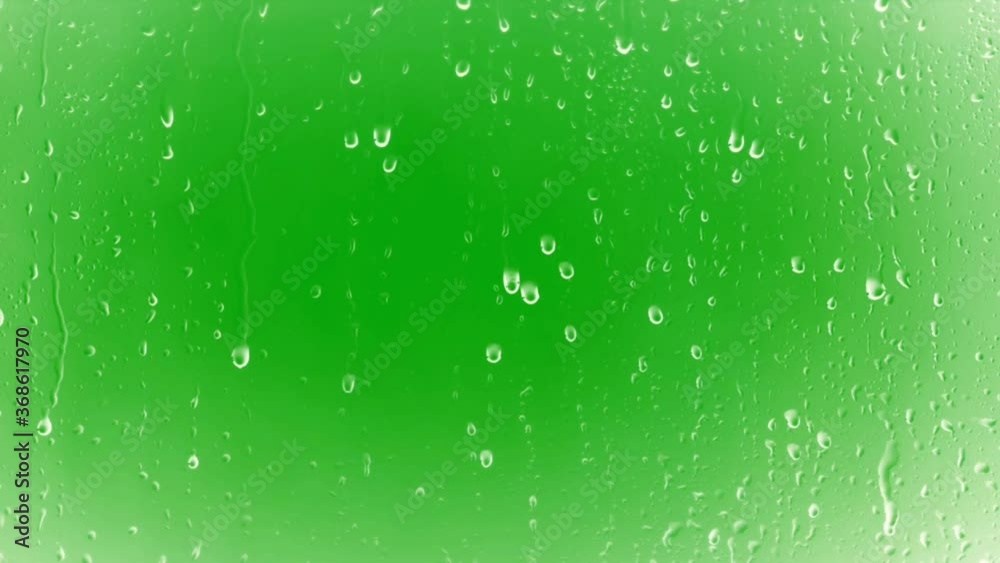 Rain drops on glass with green screen background