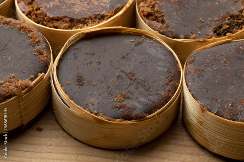 Slices of brown Palm sugar in bamboo photo