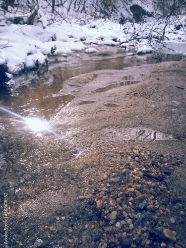 small river in the forest in the winter season