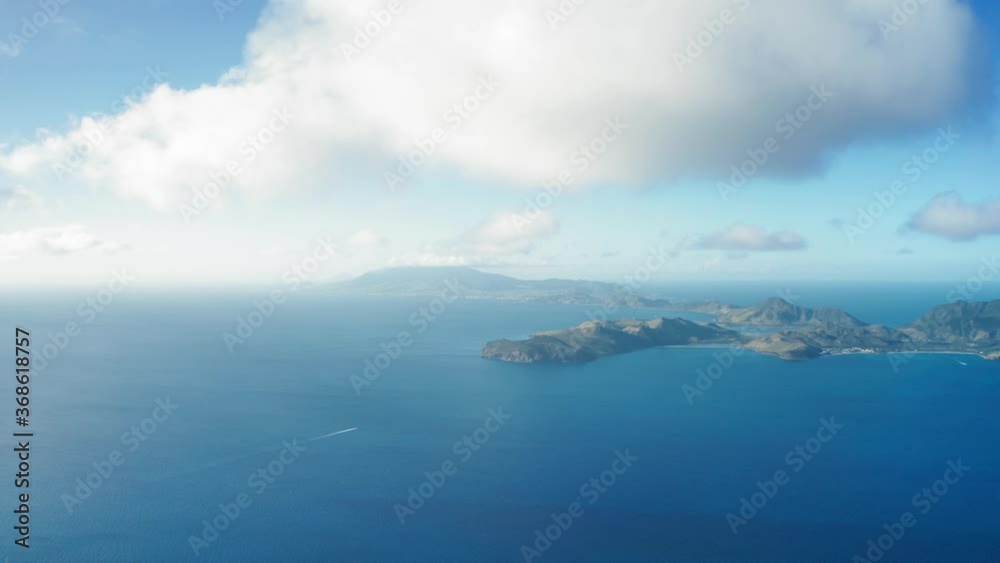 Aerial view of clouds moving over a hilly island in Saint Kitts and Nevis Aerial view of clouds moving over a hilly island in Saint Kitts and Nevis