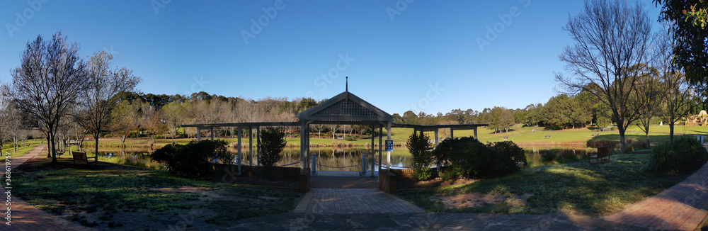 Beautiful morning view of a beautiful structure along the pond in a park with deep blue sky and tall trees, Fagan park, Galston, Sydney, New South Wales, Australia Beautiful morning view of a beautiful structure along the pond in a park with deep blue sky and tall trees, Fagan park, Galston, Sydney, New South Wales, Australia
