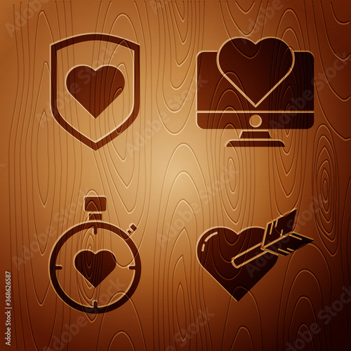 Set Amour with heart and arrow, Heart with shield, Heart in the center stopwatch and Computer monitor with heart on wooden background. Vector.