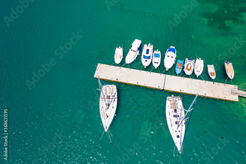 Yachts and boats in marina in town of Pirovac, beautiful Adriatic sea in Croatia, drone overhead view, green sea surface photo