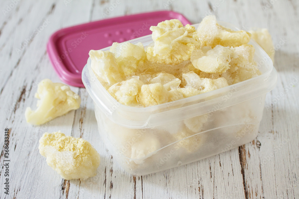 Healthy frozen food for the winter. Containers with frozen cauliflower. Healthy frozen food for the winter. Containers with frozen cauliflower.