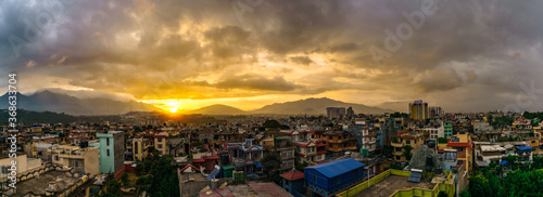 Panorama of the skyline and populated urban scenery of Kathmandu valley, Nepal, with the cloudy sky during sunset. #368633704