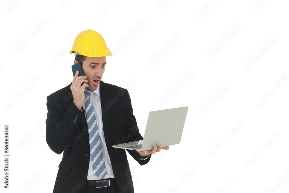 Handsome engineer in suit and white shirt and Wearing a yellow safety engineering hat with hand holding laptop and smartphone speaking and working in project isolated on White background. Handsome engineer in suit and white shirt and Wearing a yellow safety engineering hat with hand holding laptop and smartphone speaking and working in project isolated on White background.
