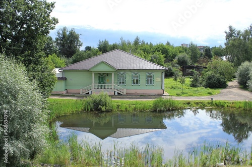 Beautiful wooden house by the pond. Russia.
