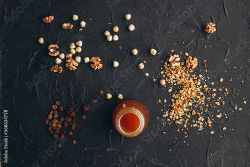 Fototapeta Naklejka Na Ścianę i Meble -  a delicious serving of granola on a dark textured table
