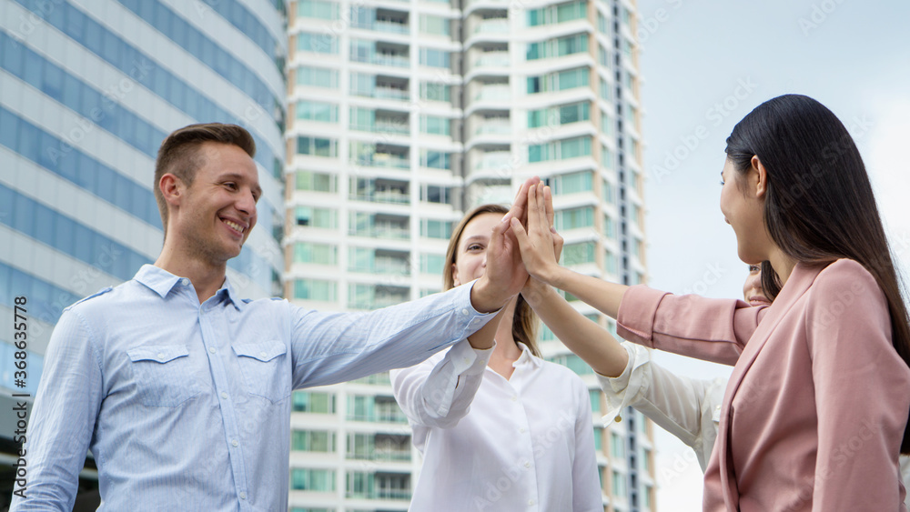 business people hands hi-five against building business people hands hi-five against building