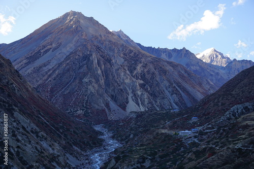 Barren and snowless mountains in the Himalayas. View of mountains and Marsyangdi river in Upper Manang, Nepal.  photo