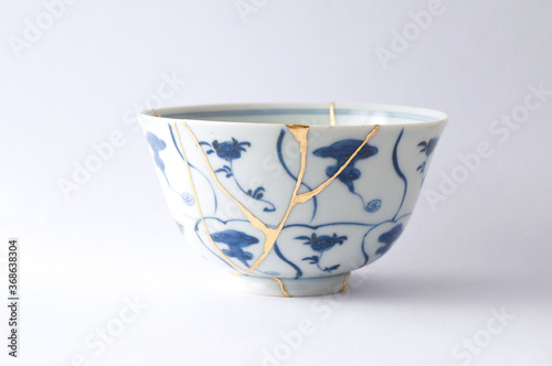 Antique Japanese ceramic kintsugi bowl restored with gold.  Antique kintsukuroi technique.