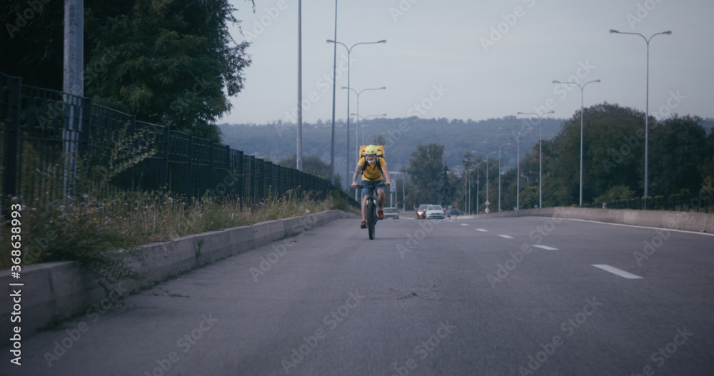 Bicycle messenger cycling on a road Bicycle messenger cycling on a road