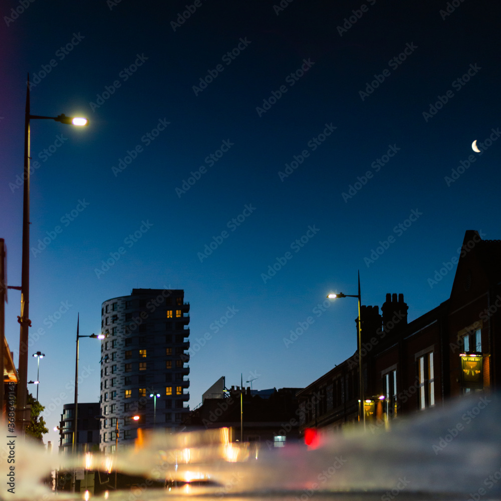 Reflection of urban buildings in a puddle of rain water at night Stock ...