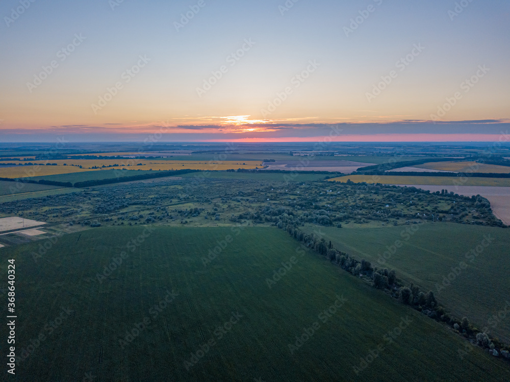Sunset over the agricultural fields of Ukraine. Aerial drone view.