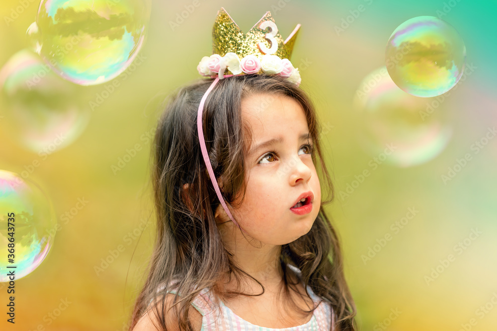 3-year-old birthday girl playing with soap bubbles outdoors 3-year-old birthday girl playing with soap bubbles outdoors