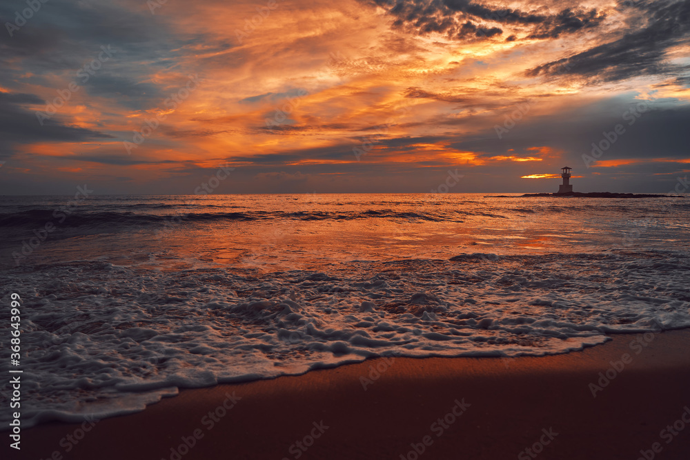 Seascape at sunset. Lighthouse on the coast