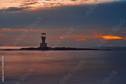 Obraz na płótnie Seascape at sunset. Lighthouse on the coast. long shutter shot w salonie