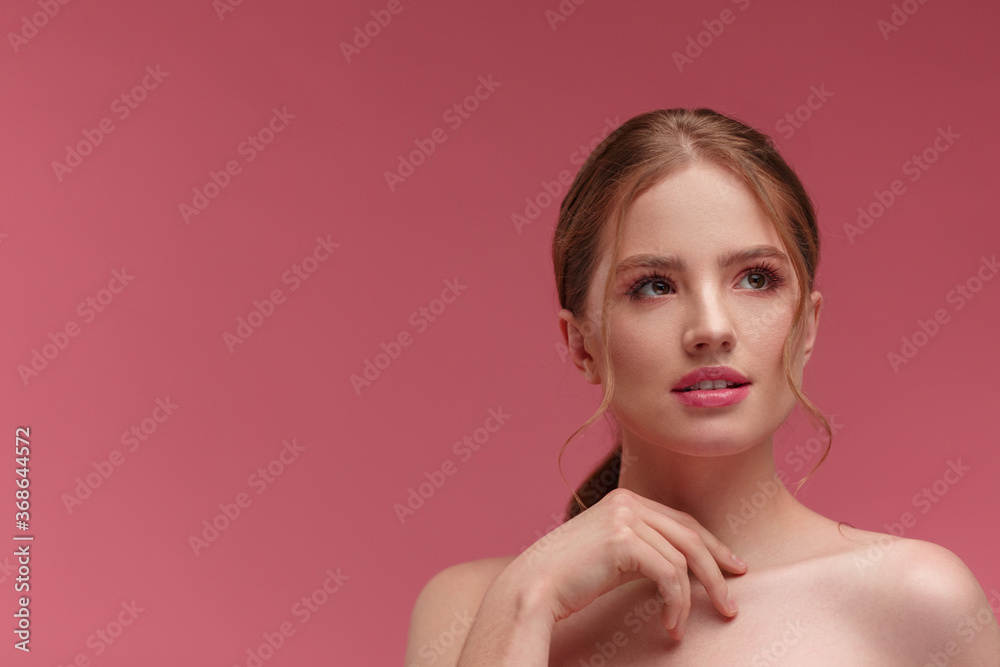 Beauty portrait of smiling redhead girl. Perfect skin. Beautiful female model with long hair over pink background. Young cute woman with clear skin. Skincare and facial treatment concept. Beauty portrait of smiling redhead girl. Perfect skin. Beautiful female model with long hair over pink background. Young cute woman with clear skin. Skincare and facial treatment concept.