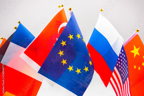 Small flags of different countries. Concept - international community. Communities of large states. Symbols of different states nearby. Russia. USA. European Union. China. Concept - diplomacy.
