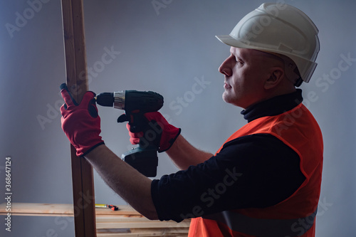 Builder tightens the screw....