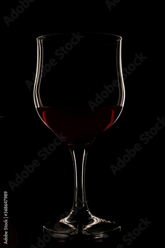 Wine glass on a black background with a white outline