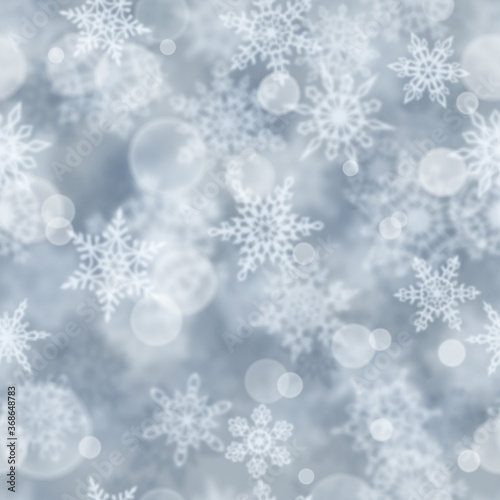 Christmas seamless pattern of blurry snowflakes on gray background