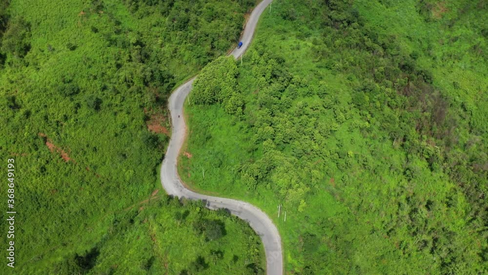 A road in the middle of forests and mountains in Asia, Laos, between Vientiane and Luang Prabang, in summer, on a sunny day. A road in the middle of forests and mountains in Asia, Laos, between Vientiane and Luang Prabang, in summer, on a sunny day.