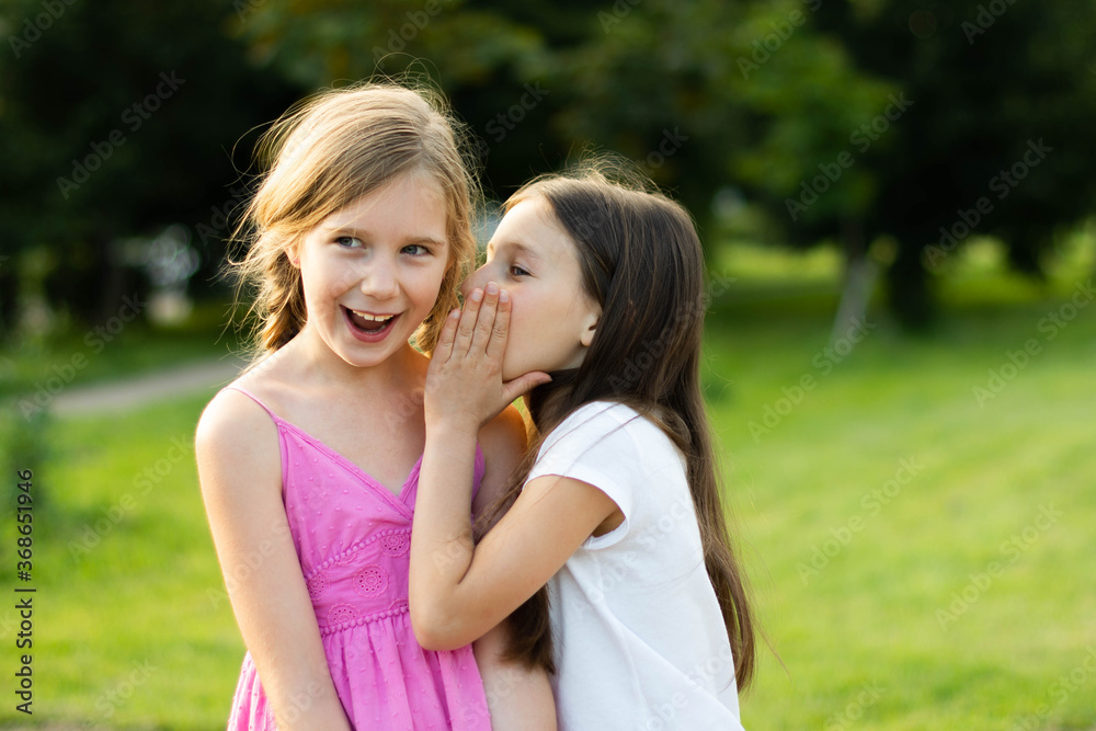 a girl shares a secret with her friend a girl shares a secret with her friend