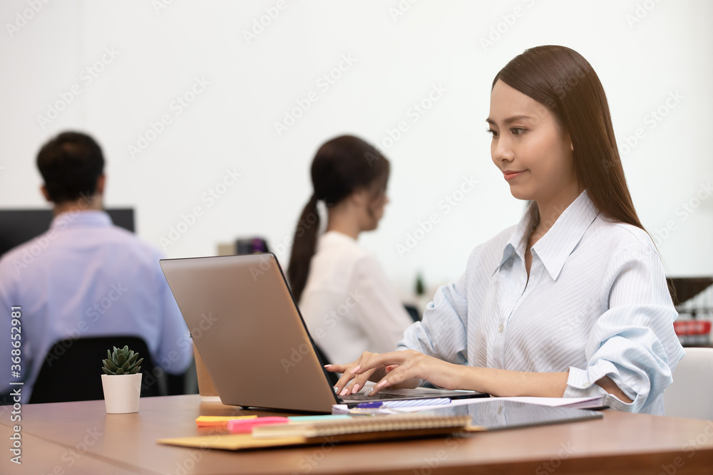 Business asian woman happy working job on laptop in office. Business asian woman happy working job on laptop in office.