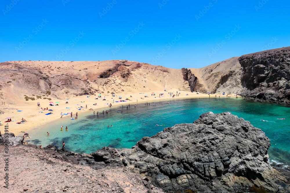 Scenic view of Papagayo Beach and the surrounding volcanic landscape in Costa Blanca, Yaiza, Lanzarote, Canary Islands, Spain. 