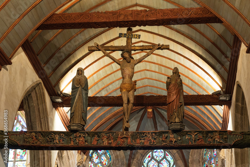 Lampaul-Guimiliau, FRANCE - JULY 14, 2020: Wooden crucifix of Jesus Christ in parish Notre Dame church. The Notre-Dame of Lampaul-Guimiliau was built in the sixteenth century. photo