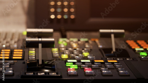 Blur image video switch of Television Broadcast, working with video and audio mixer, control broadcasts in recording studio. Broadcasting in the studio, professional mixing sender color buttons.