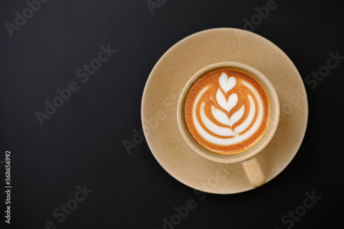 cup of coffee and coffee latte on table background
