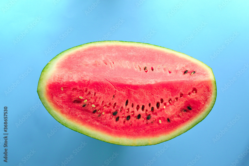 Fresh sliced watermelon isolated on blue background. Ripe watermelon crimson color. Minimal creative concept. Place for text. Bright healthy summer food. Fresh sliced watermelon isolated on blue background. Ripe watermelon crimson color. Minimal creative concept. Place for text. Bright healthy summer food.