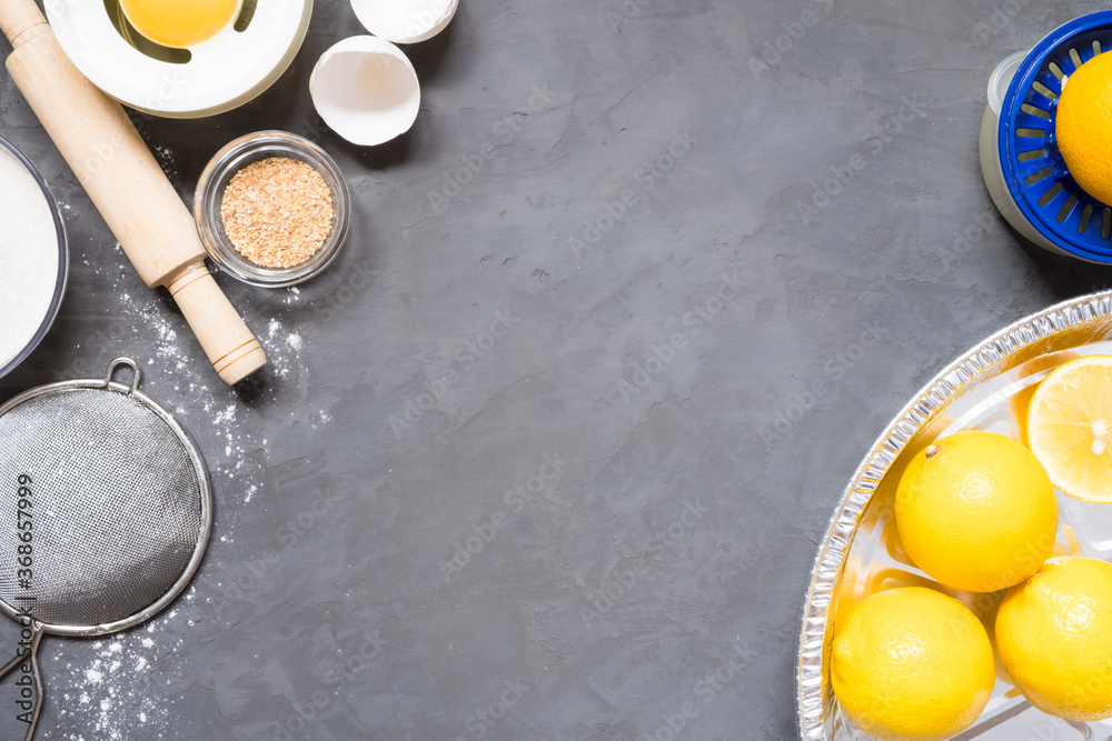 Top view raw ingredients for cooking lemon pie on wooden background with copy space. Bakery background. Top view raw ingredients for cooking lemon pie on wooden background with copy space. Bakery background.