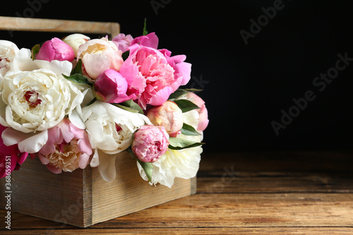 Bouquet of beautiful peonies on wooden table. Space for text © New Africa