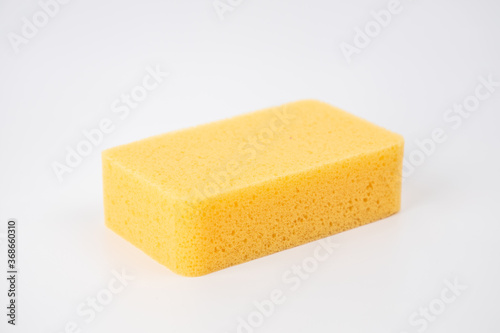 Sponge on white background. Yellow household cleaning sponge.