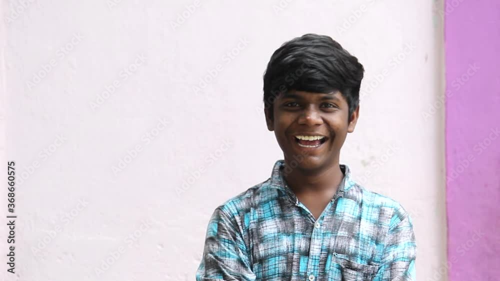 Portrait of an Indian kid laughing while staring at the camera