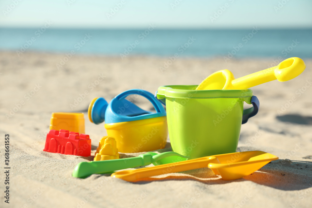Different child plastic toys on sandy beach Different child plastic toys on sandy beach