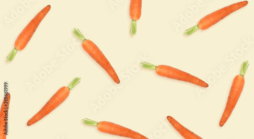 Whole carrots on beige background, banner. Pattern design