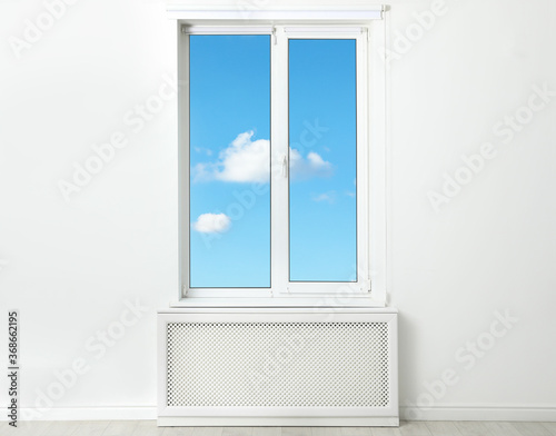 Beautiful view on blue sky with clouds through window in room