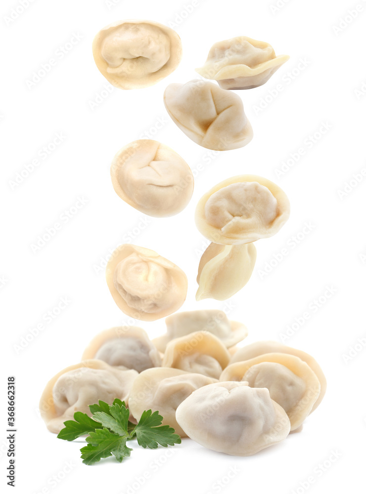 Many tasty dumplings falling on white background Many tasty dumplings falling on white background